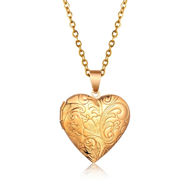 A gold heart locket with a floral lid.