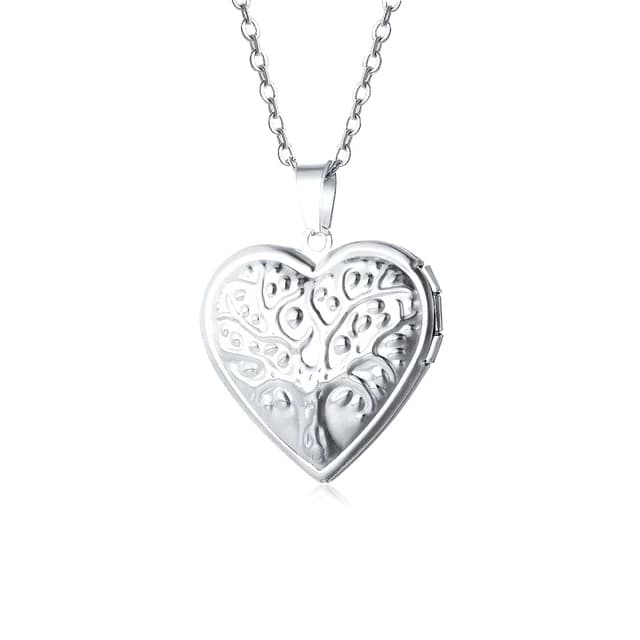 A silver heart locket engraved with a tree.