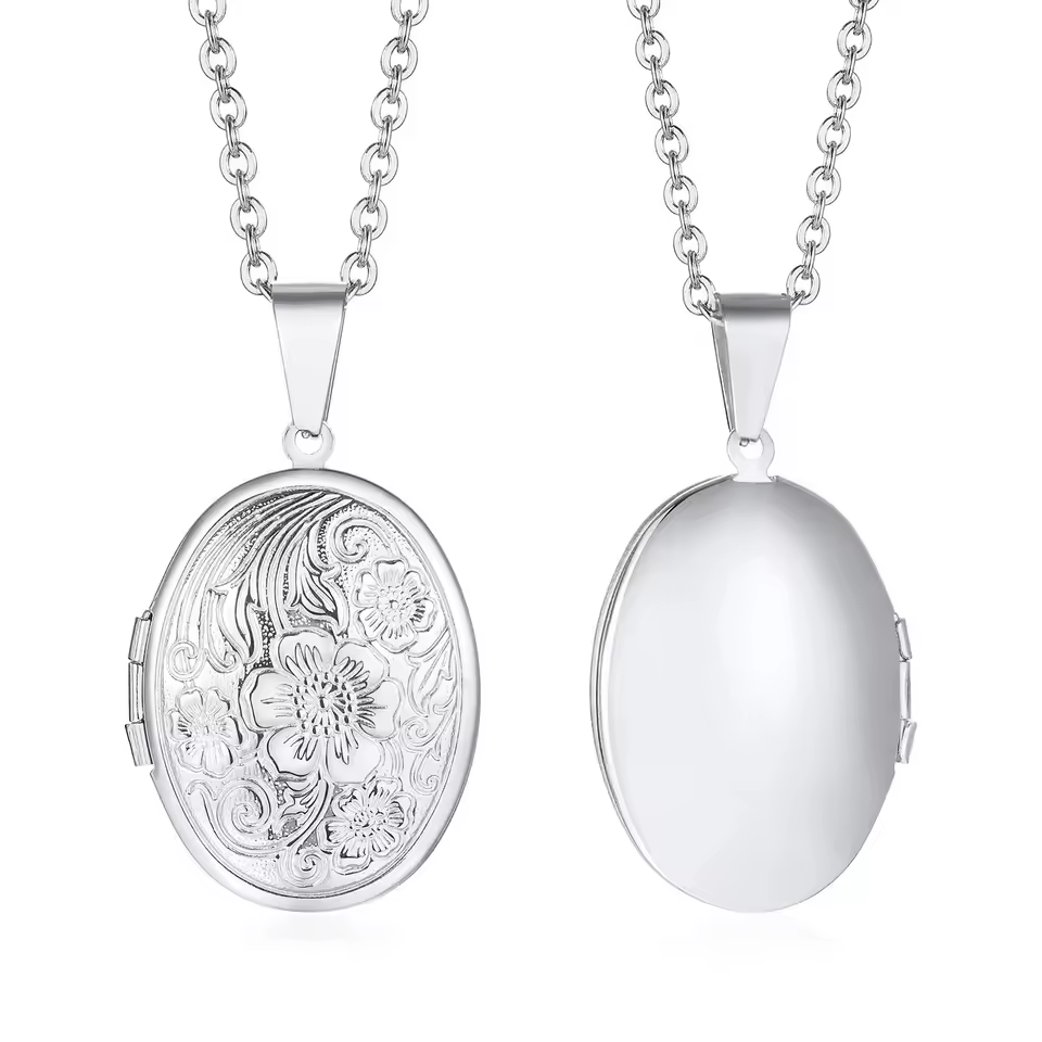 A silver oval locket with a floral lid.